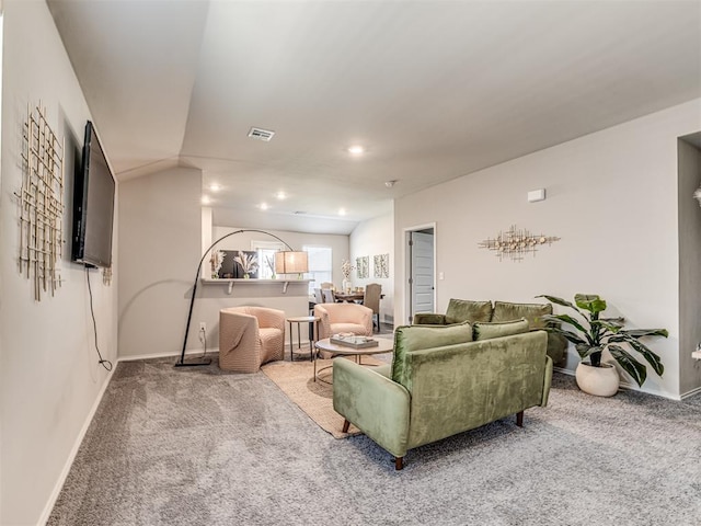1316 Chuck Wagon Dr, El Reno, OK 73036 - carpeted living area featuring lofted ceiling and baseboards