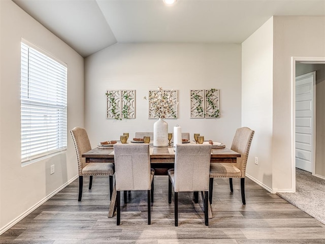 1316 Chuck Wagon Dr, El Reno, OK 73036 - dining room featuring wood finished floors, lofted ceiling, and baseboards