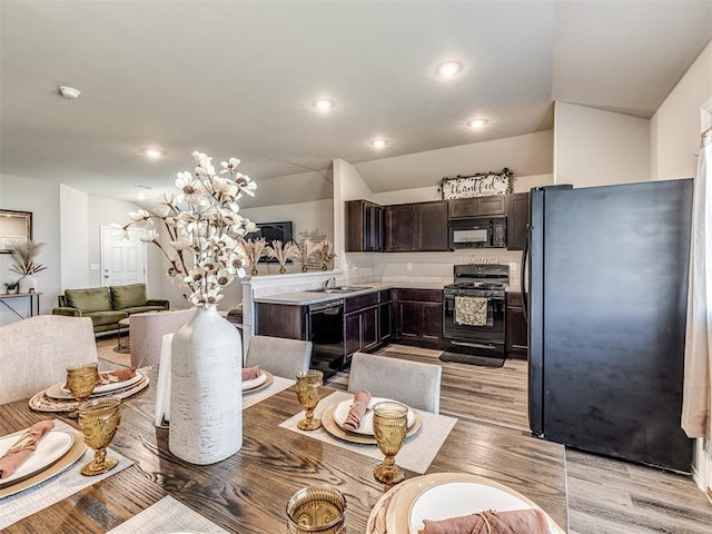 1316 Chuck Wagon Dr, El Reno, OK 73036 - dining space with light wood finished floors, recessed lighting, and vaulted ceiling