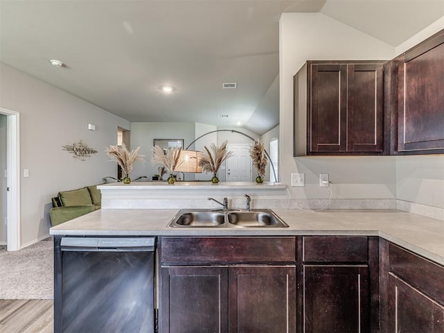 1316 Chuck Wagon Dr, El Reno, OK 73036 - kitchen featuring stainless steel dishwasher, a sink, a peninsula, dark brown cabinets, and light countertops