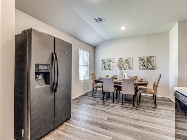 1316 Chuck Wagon Dr, El Reno, OK 73036 - dining space with light wood finished floors, baseboards, and lofted ceiling