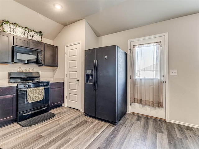 1316 Chuck Wagon Dr, El Reno, OK 73036 - kitchen with black appliances, light wood finished floors, light countertops, and vaulted ceiling