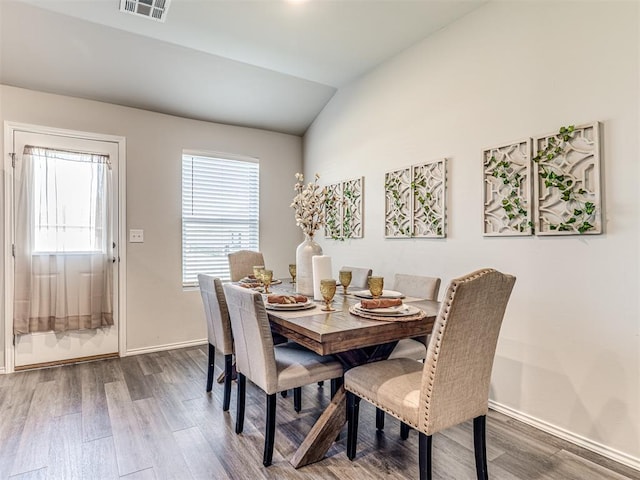 1316 Chuck Wagon Dr, El Reno, OK 73036 - dining room featuring wood finished floors, plenty of natural light, vaulted ceiling, and baseboards
