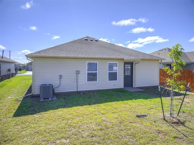 1316 Chuck Wagon Dr, El Reno, OK 73036 - rear view of house with central AC unit and a shingled roof