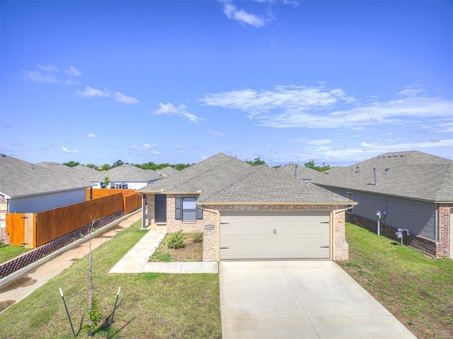 1316 Chuck Wagon Dr, El Reno, OK 73036 - view of front of house with brick siding, a garage, driveway, and roof with shingles