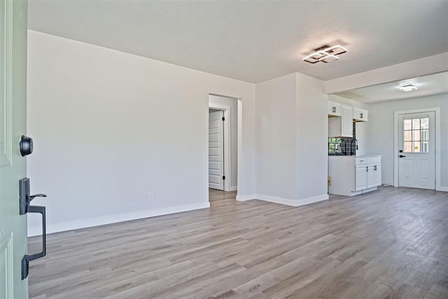 3804 NW 19th St, Oklahoma City, OK 73107 - unfurnished living room with light wood-type flooring and baseboards
