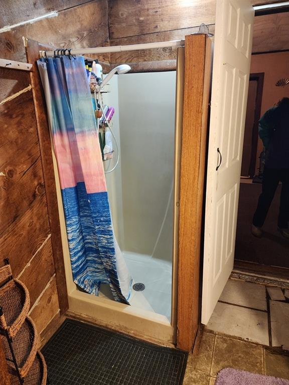 310 Mcgee St, Eufaula, OK 74432 - full bath featuring a shower stall and wood walls