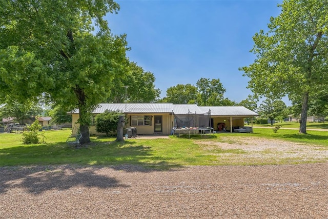 901 Cheorkee St, Vian, OK 74962 - back of property featuring a yard, dirt driveway, metal roof, and a carport