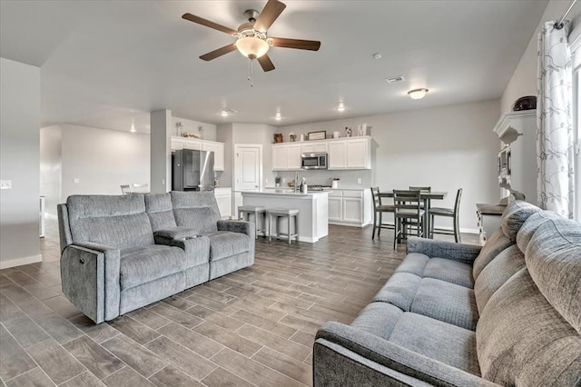 13091 Mannington Rd, Edmond, OK 73025 - living area featuring ceiling fan, baseboards, wood finished floors, and recessed lighting