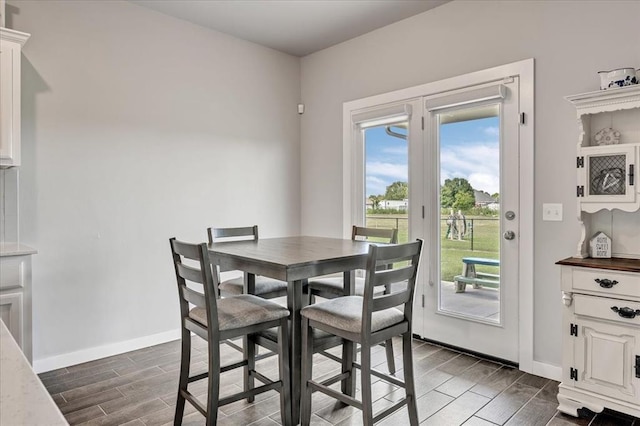 13091 Mannington Rd, Edmond, OK 73025 - dining area featuring wood tiled floors and baseboards