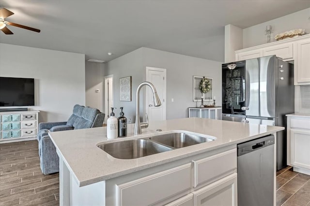 13091 Mannington Rd, Edmond, OK 73025 - kitchen with appliances with stainless steel finishes, a sink, ceiling fan, open floor plan, and a center island with sink