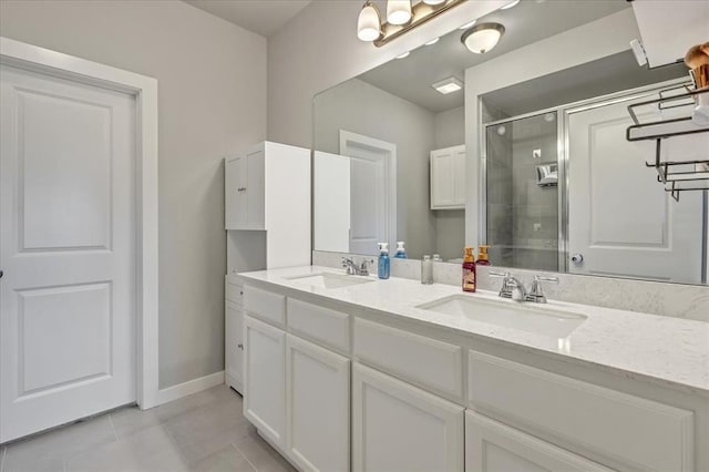 13091 Mannington Rd, Edmond, OK 73025 - bathroom with a shower stall, double vanity, tile patterned floors, and baseboards