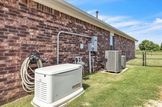 13091 Mannington Rd, Edmond, OK 73025 - exterior view of a power unit, central air condition unit, brick siding, a gate, and electric meter