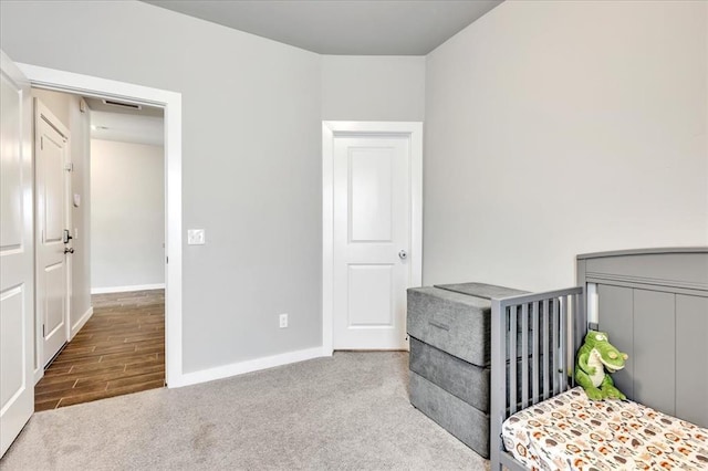 13091 Mannington Rd, Edmond, OK 73025 - bedroom with baseboards, carpet, and wood finished floors