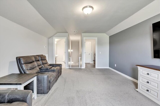 13091 Mannington Rd, Edmond, OK 73025 - living area featuring light colored carpet, lofted ceiling, and baseboards