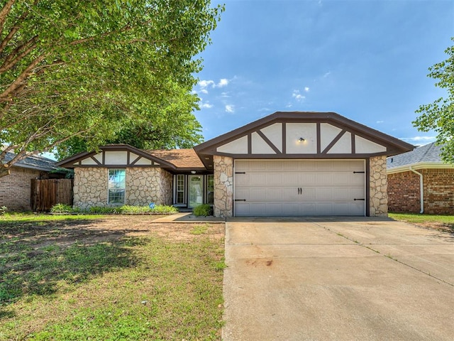 644 NW 18th St, Moore, OK 73160 - view of front of house with stone siding, an attached garage, driveway, and stucco siding