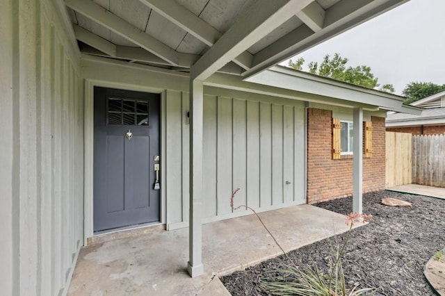 2617 SW 69th St, Oklahoma City, OK 73159 - doorway to property featuring board and batten siding and brick siding