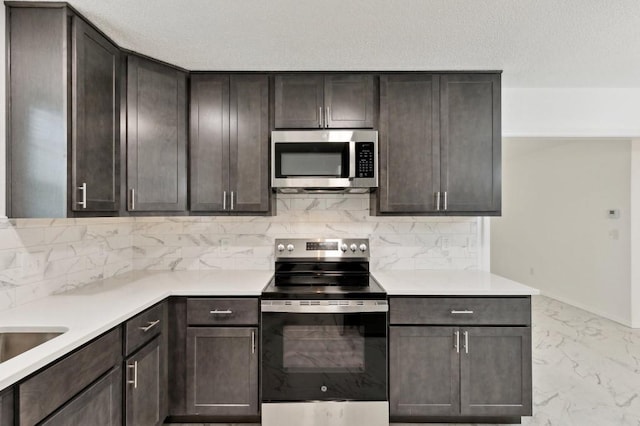 2617 SW 69th St, Oklahoma City, OK 73159 - kitchen with stainless steel appliances, decorative backsplash, light marble finish floors, and dark brown cabinets