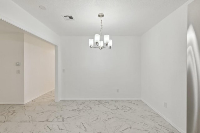 2617 SW 69th St, Oklahoma City, OK 73159 - empty room featuring light marble finish flooring, a chandelier, and a textured ceiling