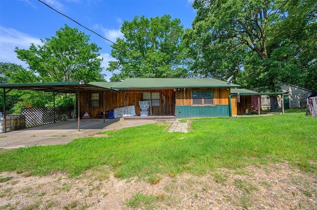 431 Canoe Rd, Broken Bow, OK 74728 - view of front of home featuring board and batten siding, a front yard, an attached carport, and driveway