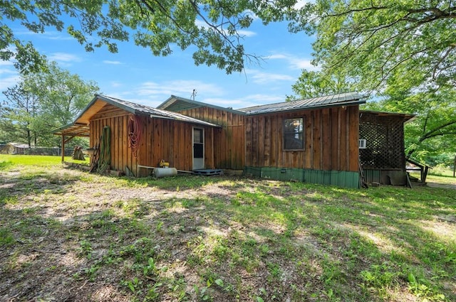 431 Canoe Rd, Broken Bow, OK 74728 - back of house featuring board and batten siding and metal roof