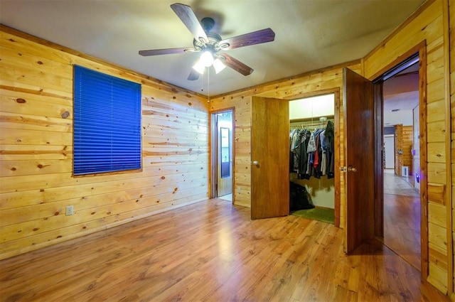 431 Canoe Rd, Broken Bow, OK 74728 - empty room featuring wooden walls, ceiling fan, and wood finished floors
