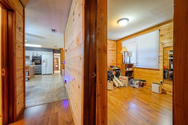 431 Canoe Rd, Broken Bow, OK 74728 - corridor with wood walls and wood finished floors