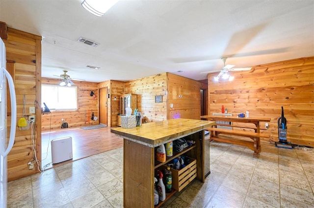 431 Canoe Rd, Broken Bow, OK 74728 - kitchen with ceiling fan, wood walls, wooden counters, open shelves, and freestanding refrigerator
