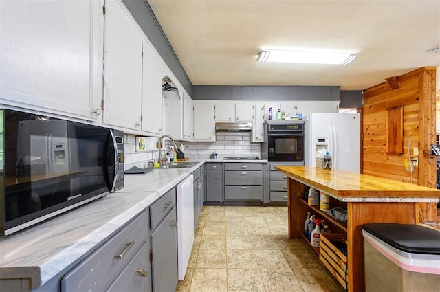 431 Canoe Rd, Broken Bow, OK 74728 - kitchen with oven, gray cabinets, a sink, white refrigerator with ice dispenser, and under cabinet range hood