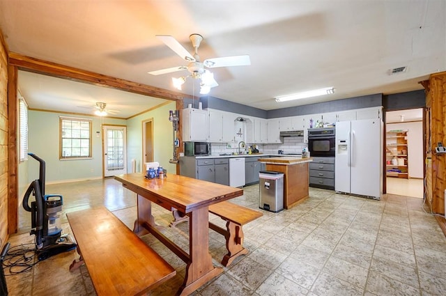 431 Canoe Rd, Broken Bow, OK 74728 - kitchen featuring black appliances, a ceiling fan, light countertops, a kitchen island, and under cabinet range hood
