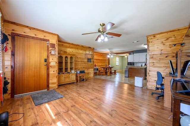 431 Canoe Rd, Broken Bow, OK 74728 - home office with wood walls, ceiling fan, and light wood-style flooring