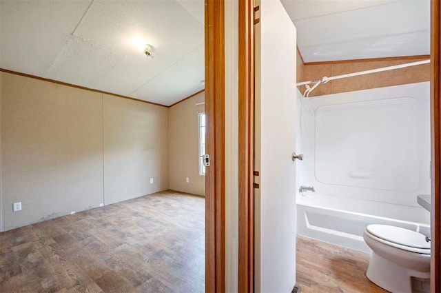 2991 Peavey Xing, Broken Bow, OK 74728 - bathroom featuring lofted ceiling, wood finished floors, toilet, and bathtub / shower combination