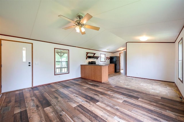 2991 Peavey Xing, Broken Bow, OK 74728 - kitchen featuring a peninsula, hardwood / wood-style flooring, freestanding refrigerator, lofted ceiling, and a ceiling fan