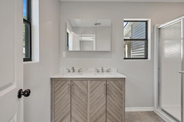 2901 Pine Ave, Oklahoma City, OK 73126 - bathroom with double vanity, healthy amount of natural light, and a shower with shower door