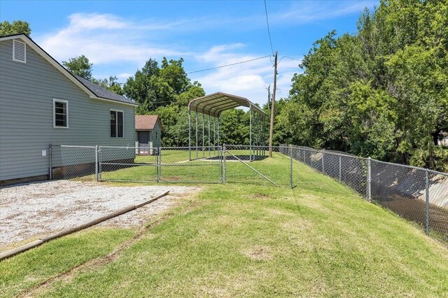2901 Pine Ave, Oklahoma City, OK 73126 - view of yard featuring a detached carport, a gate, and driveway