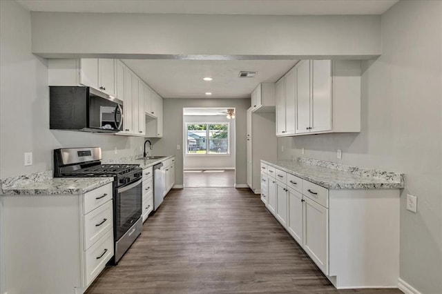 2901 Pine Ave, Oklahoma City, OK 73126 - kitchen featuring stainless steel appliances, dark wood-style floors, ceiling fan, white cabinetry, and recessed lighting