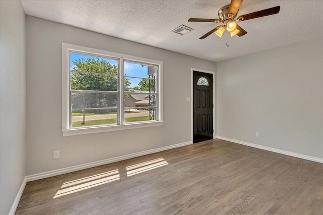 2901 Pine Ave, Oklahoma City, OK 73126 - entrance foyer with wood finished floors, a textured ceiling, and a ceiling fan