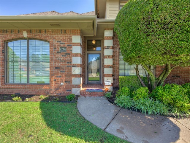 3713 Barwick Ct, Norman, OK 73072 - entrance to property featuring brick siding, a lawn, and a shingled roof