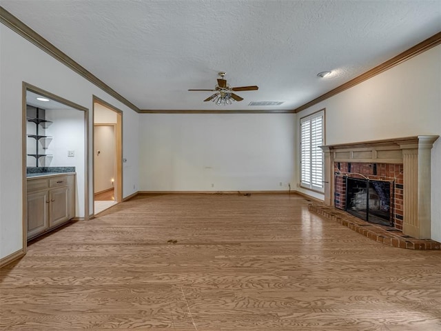 3713 Barwick Ct, Norman, OK 73072 - unfurnished living room featuring ceiling fan, light wood finished floors, a fireplace, ornamental molding, and baseboards