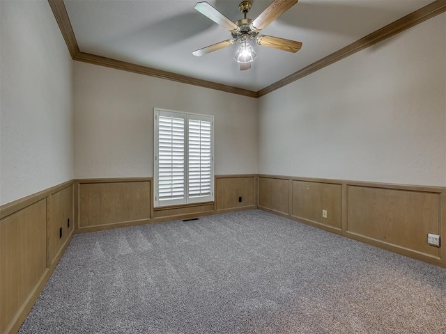 3713 Barwick Ct, Norman, OK 73072 - spare room featuring crown molding, wainscoting, a ceiling fan, and carpet floors