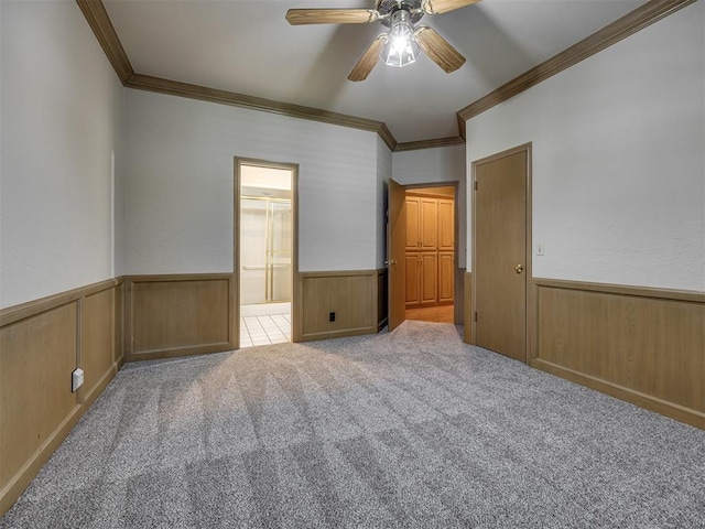 3713 Barwick Ct, Norman, OK 73072 - unfurnished bedroom with ornamental molding, wainscoting, carpet flooring, ensuite bath, and ceiling fan