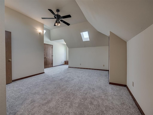 3713 Barwick Ct, Norman, OK 73072 - bonus room featuring a skylight, vaulted ceiling, carpet floors, a ceiling fan, and baseboards