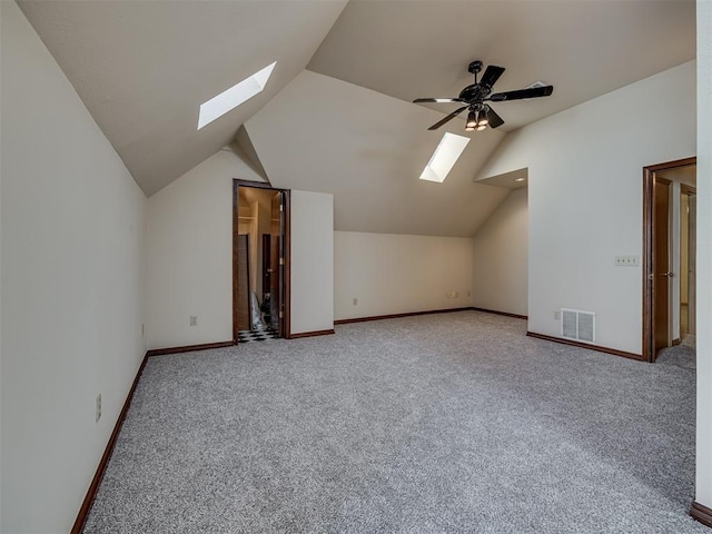 3713 Barwick Ct, Norman, OK 73072 - bonus room featuring a skylight, vaulted ceiling, carpet floors, baseboards, and a ceiling fan