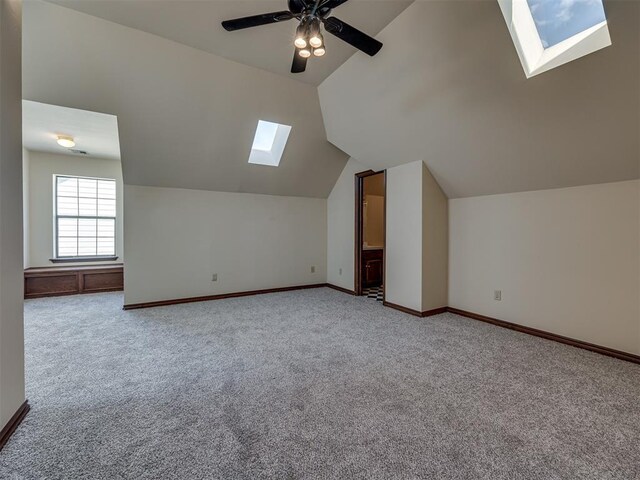 3713 Barwick Ct, Norman, OK 73072 - additional living space with a skylight, carpet floors, lofted ceiling, baseboards, and ceiling fan