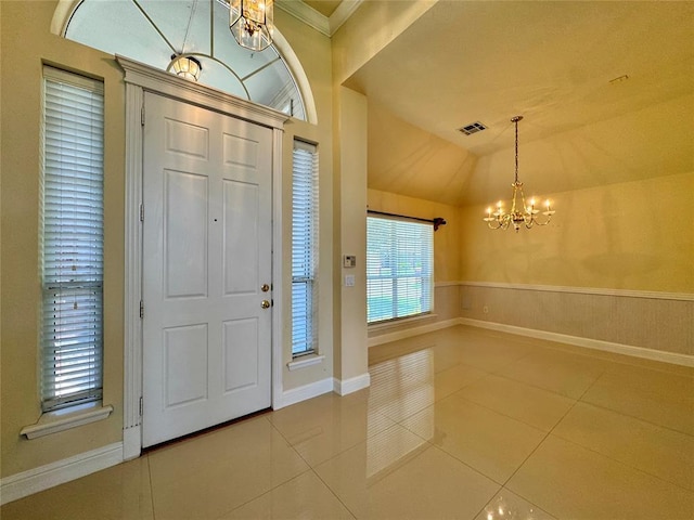 4409 Whitmere Ct, Norman, OK 73072 - tiled foyer entrance featuring a chandelier, lofted ceiling, and ornamental molding