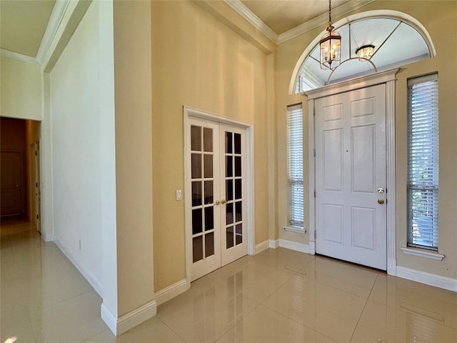 4409 Whitmere Ct, Norman, OK 73072 - tiled entrance foyer featuring french doors, a chandelier, healthy amount of natural light, and crown molding