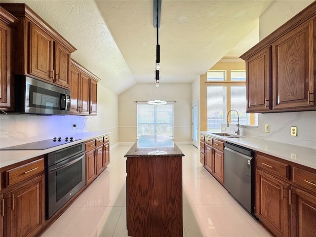 4409 Whitmere Ct, Norman, OK 73072 - kitchen with appliances with stainless steel finishes, a kitchen island, lofted ceiling, light tile patterned floors, and a textured ceiling