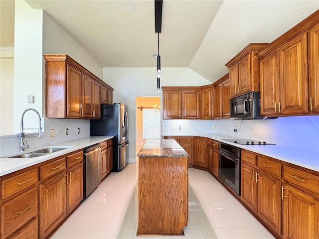 4409 Whitmere Ct, Norman, OK 73072 - kitchen with black appliances, a kitchen island, lofted ceiling, brown cabinetry, and pendant lighting