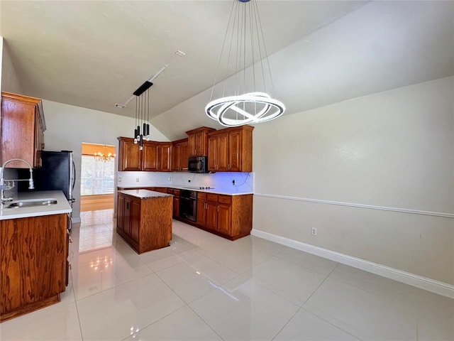 4409 Whitmere Ct, Norman, OK 73072 - kitchen featuring black appliances, vaulted ceiling, a chandelier, a kitchen island, and hanging light fixtures