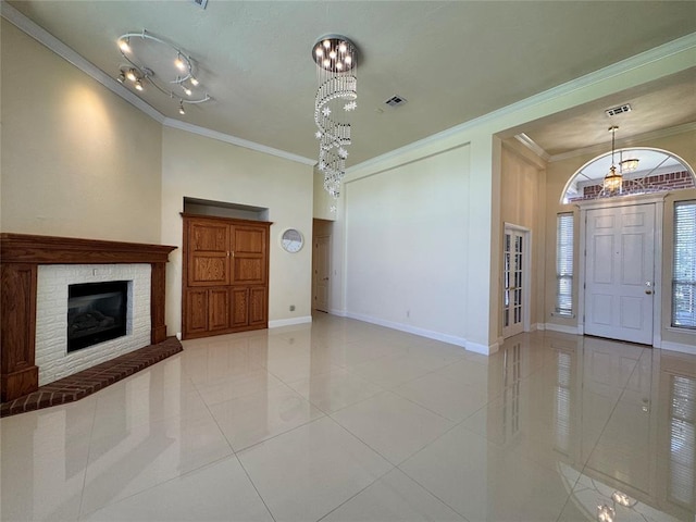 4409 Whitmere Ct, Norman, OK 73072 - unfurnished living room featuring ornamental molding, a chandelier, tile patterned floors, and a fireplace